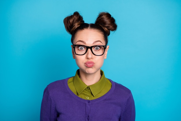 Close-up portrait of her she nice attractive pretty comic\
childish funky cheery girl holding air in cheeks humour isolated on\
bright vivid shine vibrant blue green teal turquoise color\
background