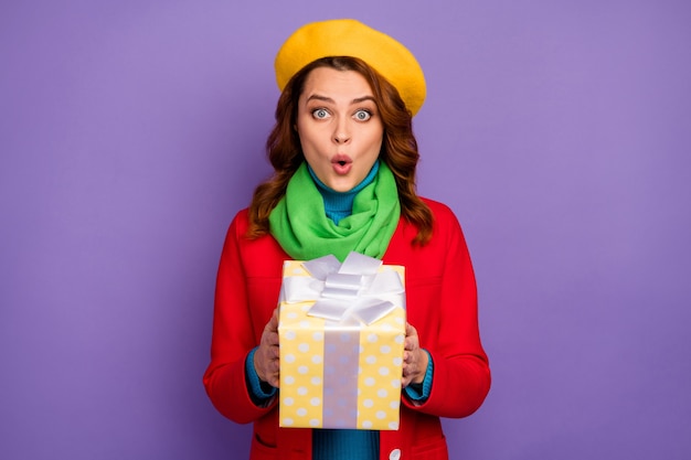 Close-up portrait of her she nice-looking attractive lovely cheerful amazed wavy-haired girl holding in hands festal giftbox pout lips isolated over violet lilac purple pastel color background