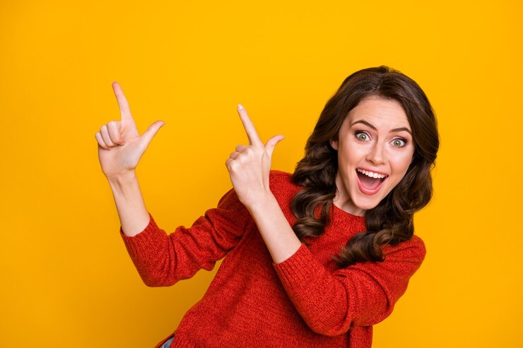 Photo close-up portrait of her she nice-looking attractive lovely cheerful cheery glad wavy-haired girl pointing forefingers up ad advert decision isolated bright vivid shine vibrant yellow color background