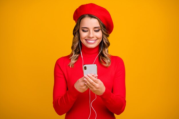 Close-up portrait of her she nice-looking attractive lovely cute cheerful cheery wavy-haired girl using device listening music isolated on bright vivid shine vibrant yellow color background