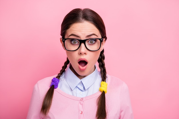 Close-up portrait of her she nice-looking attractive lovely pretty winsome funny cute amazed brown-haired teen girl geek news reaction isolated over pink pastel color background