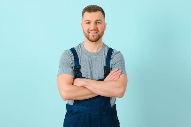 Close-up portrait of his he nice attractive cheerful cheery content guy repairer craftsman isolated over blue color background.