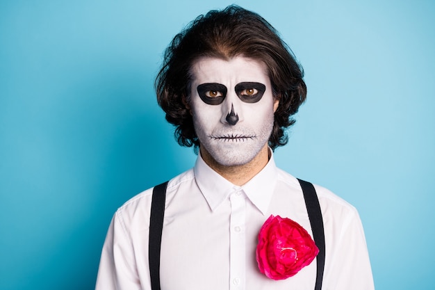 Close-up portrait of his he nice handsome serious evil guy demonic body art el dia de los Muertos Santa Muerte festive isolated bright vivid shine vibrant blue color background