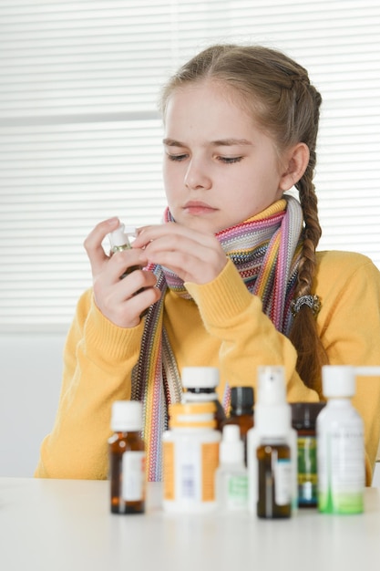 Close up portrait of ill girl taking medicine at home