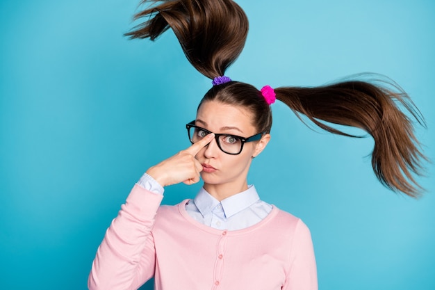 close-up portrait of intelligent funky college girl touching specs