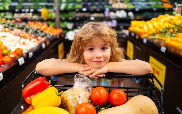 Close up portrait of kids shopping in supermarket shopping cart grocery store concept