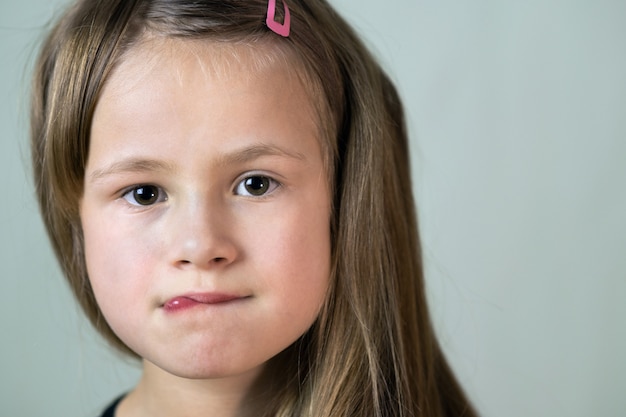 Close up portrait of little child girl with funny face expression.