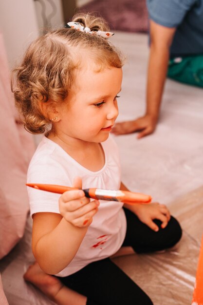 Close up portrait of little preschool age girl with brush in
hand