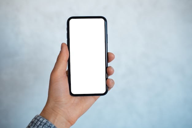 Close-up portrait of male hand, holding a smartphone