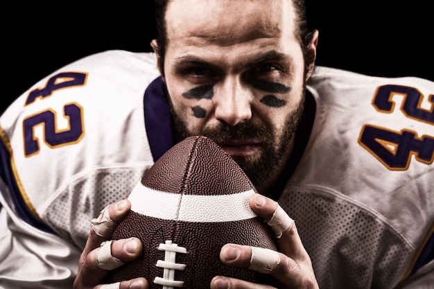 Close-up portrait of man standing against black background