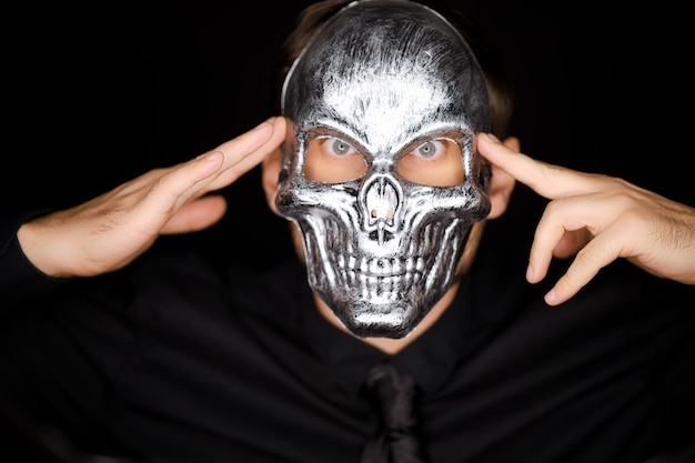 Close-up portrait of a man wearing a skeleton mask