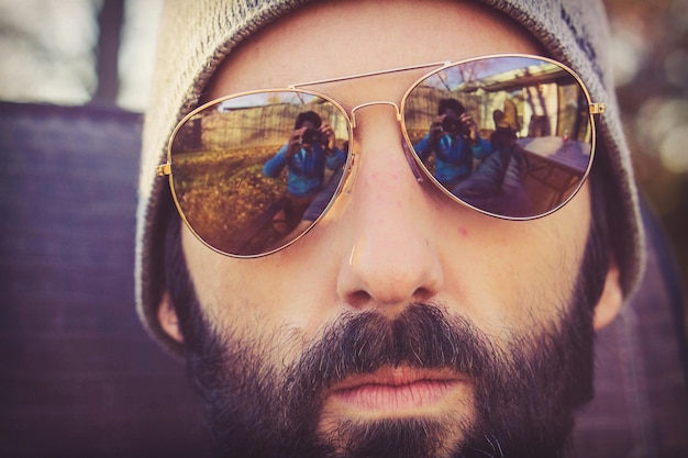 Photo close-up portrait of man wearing sunglasses standing outdoors