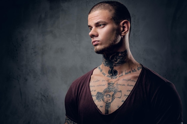 Close up portrait of a man with tattoo on his neck.