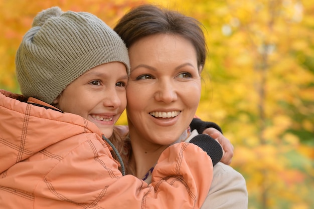 Close up portrait of mother and daughter hugging