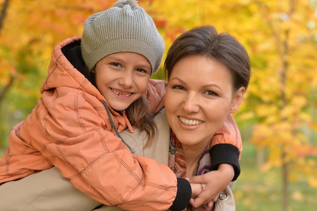 Close up portrait of mother and daughter hugging