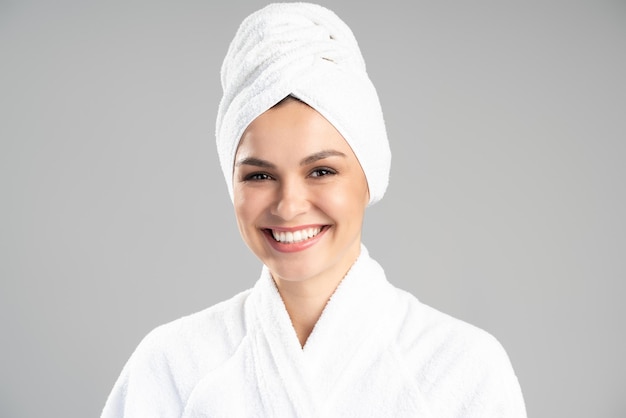 Close-up portrait of nice pretty cheerful girl wearing turban on head enjoying of her smooth perfect skin isolated over grey color background