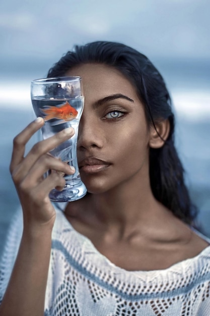 Фото Портрет молодой женщины, пьющей стакан.