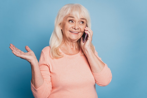 Close up portrait of old woman talking on cell