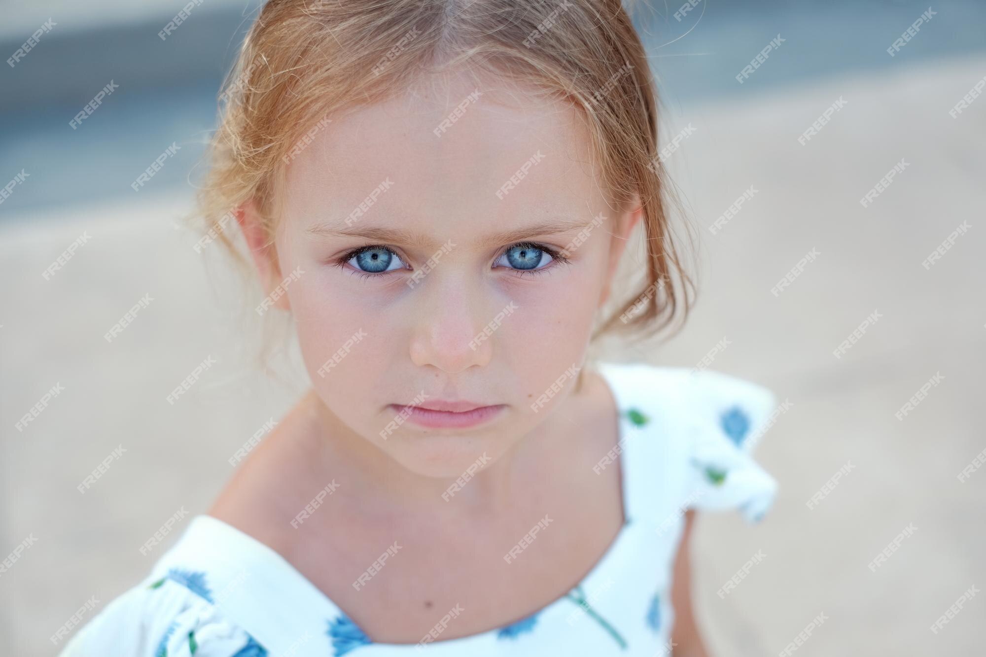 Premium Photo  Child girl sad profile face close up with hands on cheek.