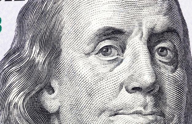 Close-up of a portrait of the president of one hundred American dollars, real paper notes of freely convertible American currency