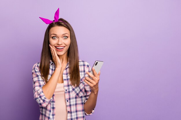 Close-up portrait of pretty cheerful glad girl holding in hand cell