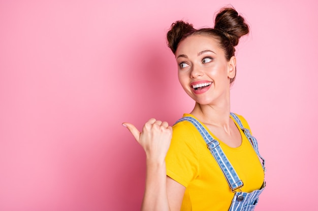 Close-up portrait of pretty glad cheerful girl demonstrating advert copy empty space