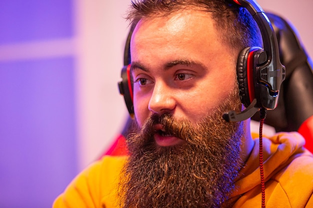 Close up portrait of professional bearded video gamer in front of his PC