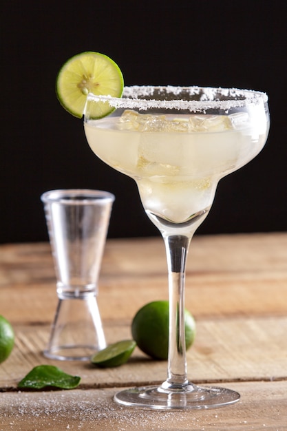 Photo close up portrait of refreshing classic margarita with lime and salt on wooden table