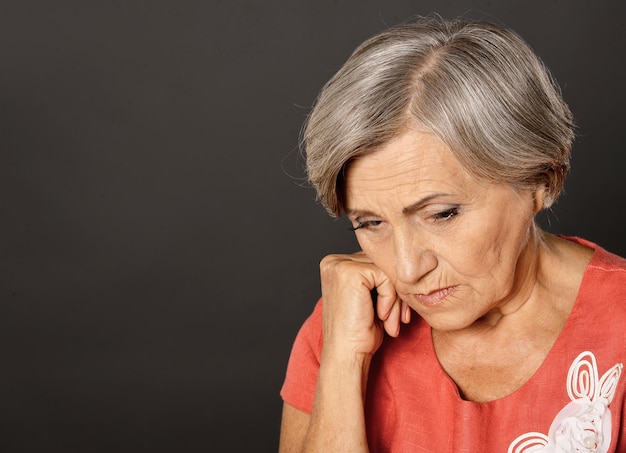 Close up portrait of sad beautiful senior woman