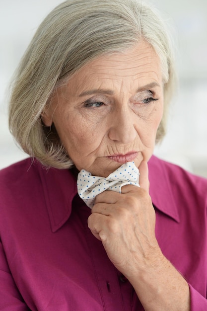 Close up portrait of sad ill senior woman