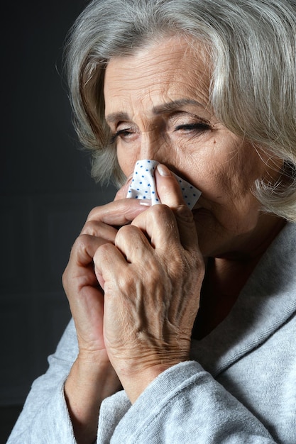 Close up portrait of sad ill senior woman