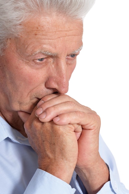 Close up portrait of sad senior man isolated on white background