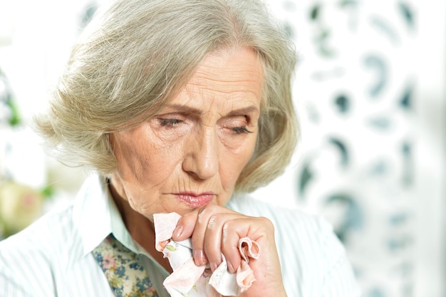 Close up portrait of Sad senior woman at home