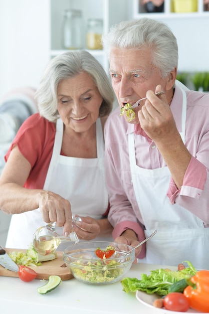 close up portrait of senior couple cooking