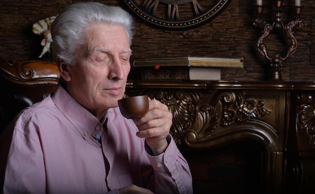 Close up portrait of senior man drinking tea