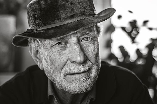 close-up portrait of senior man wearing hat