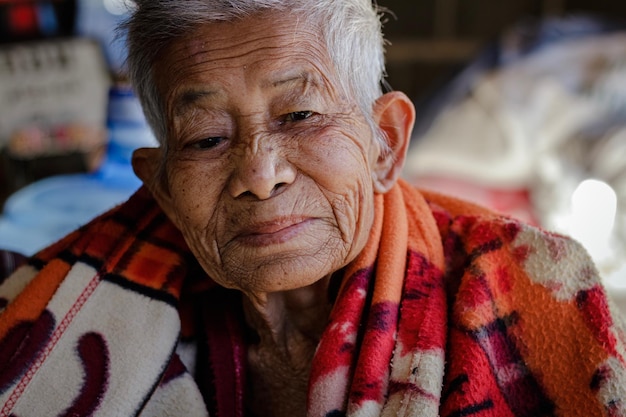 Close-up of portrait senior woman while sitting at home