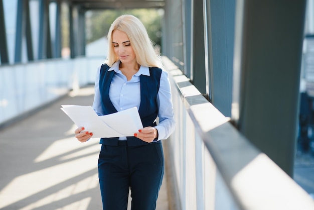 Close up portrait of a serious business woman in blue suit standing in the city