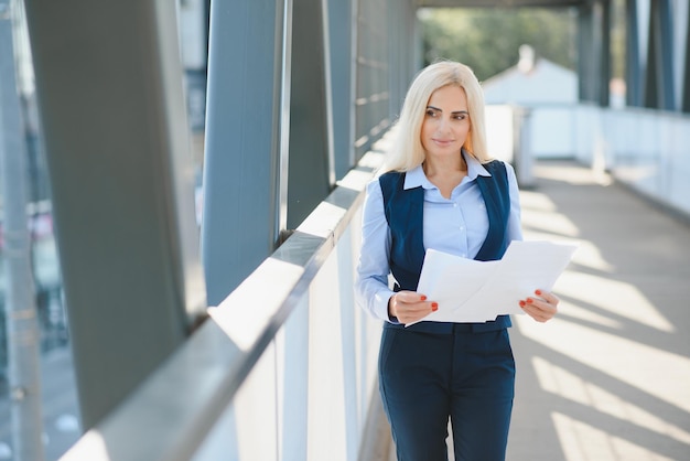 Close up portrait of a serious business woman in blue suit standing in the city