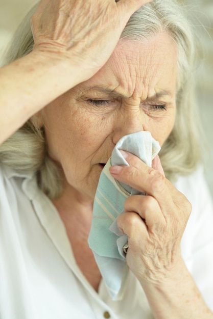 Close up portrait of sick senior woman posing at home