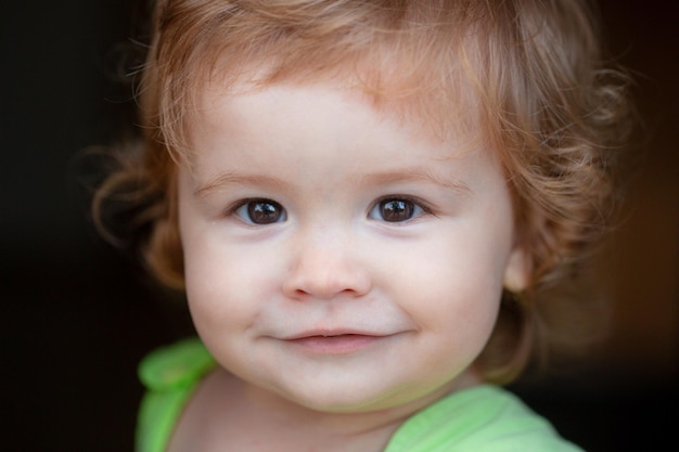Close up portrait of a small blond baby funny kids face