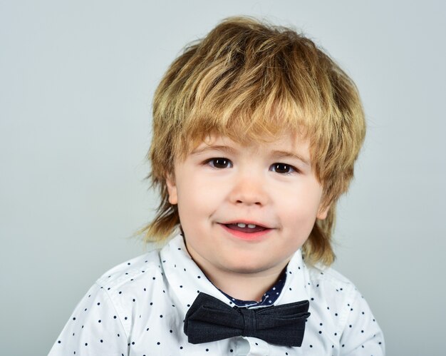 Close up portrait of small boy in white shirt child clothes kid fashion fashionable little child in