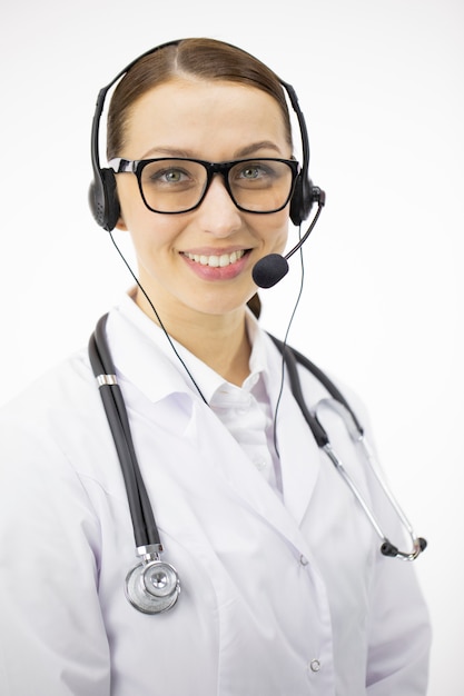 Close up portrait of smart sexy doctor in headphones smiling