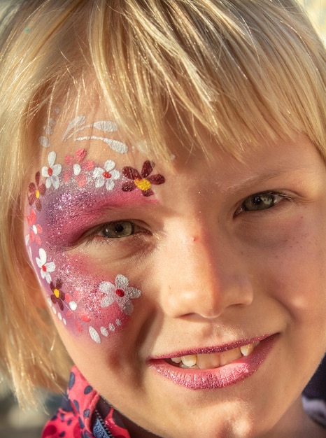 Close-up portrait of smiling girl with face paint