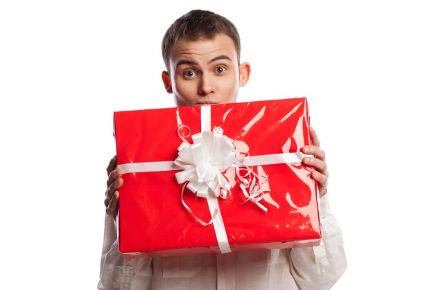 Close-up portrait of smiling man holding gift isolated on white background