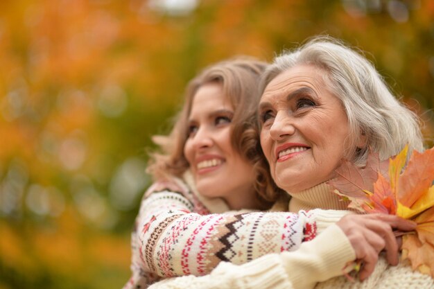 Close up portrait of smiling senior woman with adult daughter