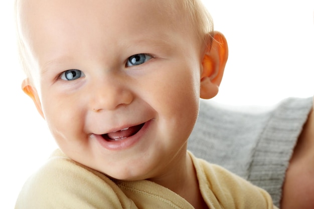 Close-up portrait of smiling son with mother against white background