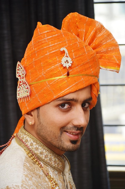 Close-up portrait of smiling young man wearing turban