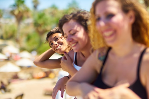 Close-up portrait of smiling young woman against blurred background