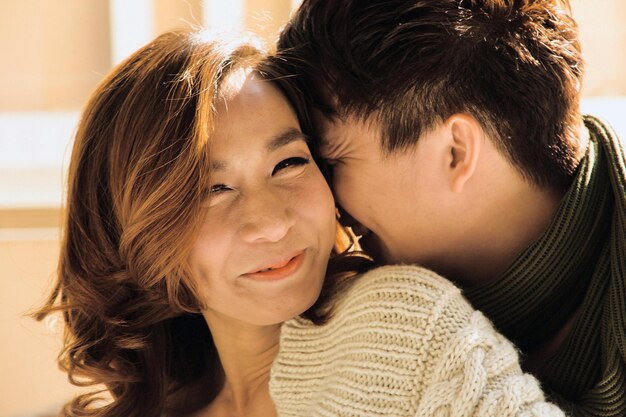 Close-up portrait of smiling young woman with man